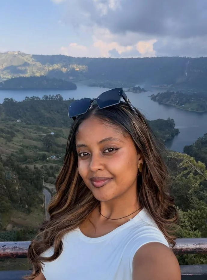 Efratah taking a portrait with Wenchi Crater Lake behind her